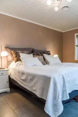 a bedroom with a large bed with white sheets and pillows at Stor enebolig i Trondheim in Trondheim