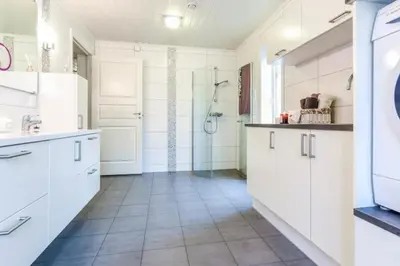 a white kitchen with a shower and a sink at Stor enebolig i Trondheim in Trondheim