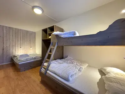 a bedroom with two bunk beds and a ladder at Spacious apartment near Hemsedal ski resort in Hemsedal