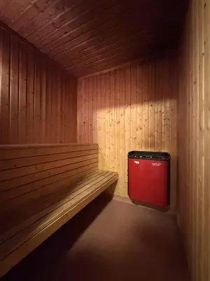 a bench in a room with a red trash can at Spacious apartment near Hemsedal ski resort in Hemsedal