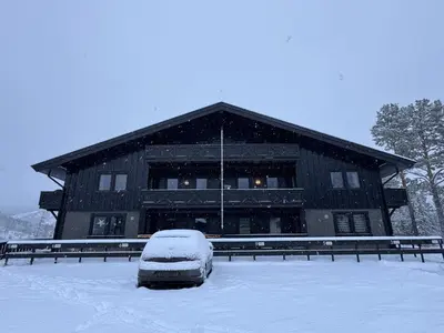 a snow covered car parked in front of a building at Spacious apartment near Hemsedal ski resort in Hemsedal