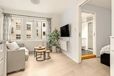 a living room with a couch and a table at Flat in Bergen house with outstanding roof terrace in Bergen