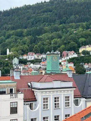a city with a clock tower on top of a building at Flat in Bergen house with outstanding roof terrace in Bergen