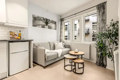 a living room with a couch and a table at Flat in Bergen house with outstanding roof terrace in Bergen