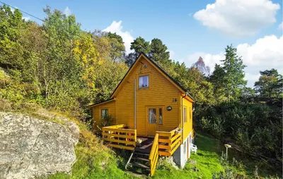 a small wooden house in the middle of a forest at 3 Bedroom Amazing Home In Reksteren in Haukafer
