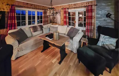 a living room with a couch and a table at 3 Bedroom Nice Home In Tuddal in Tuddal