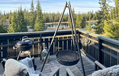 a grill on a deck with a pot and a pan at Stunning Home In Sjusjøen With Sauna in Sjusjøen