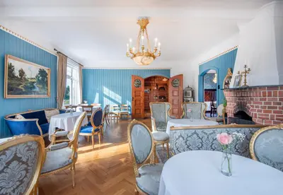 a dining room with blue walls and tables and chairs at Jervell 4 Bnb in Ålesund