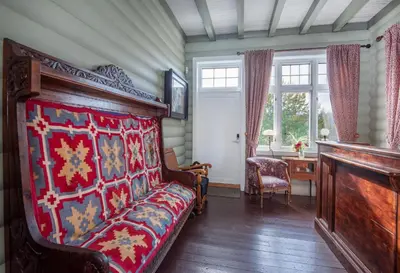 a bedroom with a bed and a desk and a window at Jervell 4 Bnb in Ålesund