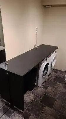 a washing machine in a room with a black counter top at Hareid in Hareid