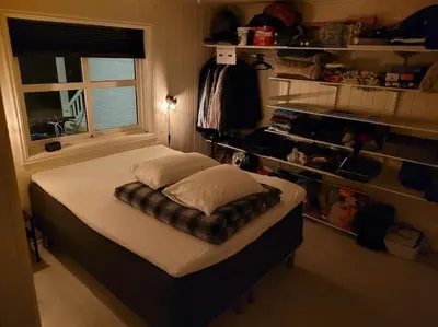 a large bed in a room with a window at Hareid in Hareid
