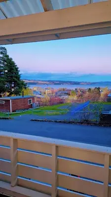 a window in a building with a view of the water at Room In Handsome Haven House in Gjøvik