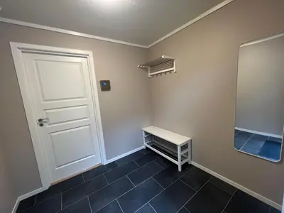a room with a white door and a mirror at Leilighet på Hardbakke in Lia