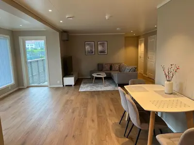 a living room with a table and a couch at Leilighet på Hardbakke in Lia