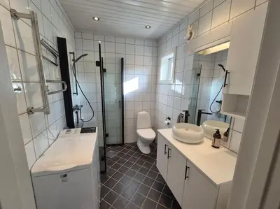 a bathroom with a sink and a toilet and a shower at Cozy Home with Sauna, river views and 10 min from Hafjell and Lillehammer in Fåberg