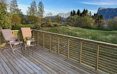 two chairs and a table on a wooden deck at Lovely Home In Sørbøvåg in Sørbø