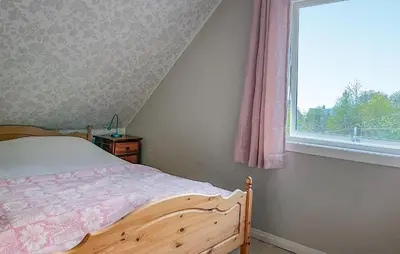 a bedroom with a bed and a window at Lovely Home In Sørbøvåg in Sørbø