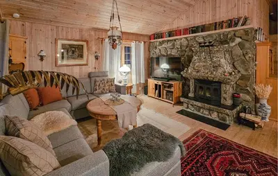 a living room with a couch and a fireplace at Gorgeous Home In Tuddal in Tuddal
