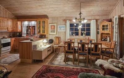 a kitchen and dining room with a table and chairs at Gorgeous Home In Tuddal in Tuddal