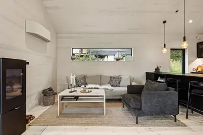 a living room with a couch and a table at Tyristua in Gjesval