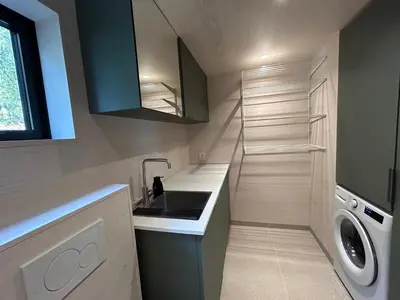 a kitchen with a sink and a washing machine at Tyristua in Gjesval