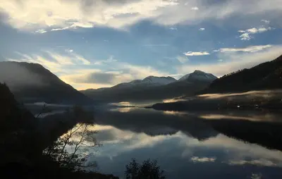 a lake in the middle of a valley with mountains at Stunning Home In Todalen in Ålvundfjord