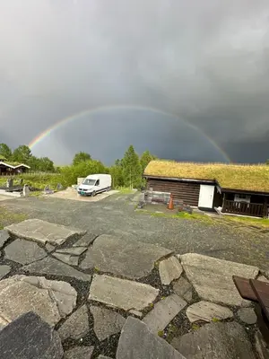 a rainbow in the sky over a rv at Hytte Oppdal Så Klart in Oppdal