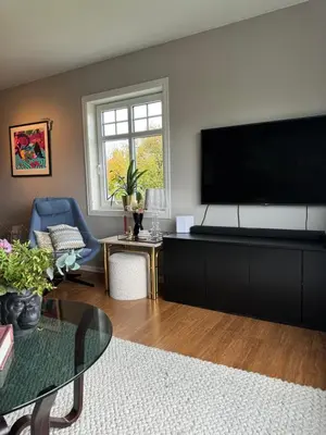 a living room with a large flat screen tv at Villa apartment in Trondheim