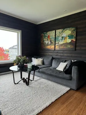 a living room with a couch and a table at Villa apartment in Trondheim