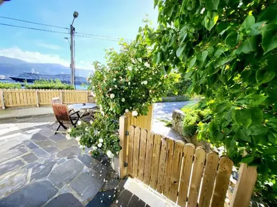 a wooden fence in a backyard with a table and chairs at OAH 1870 Oldest Alesund House in Ålesund