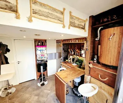 a kitchen with a table and a counter in a room at OAH 1870 Oldest Alesund House in Ålesund