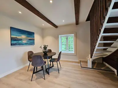 a dining room with a table and chairs and a staircase at Stort hus med 2 leiligheter til leie på Lundamo, Perfekt for større grupper! in Melhus