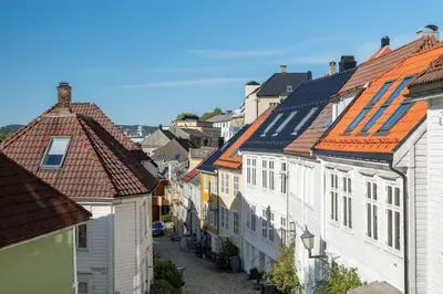 a row of houses with red roofs on a street at Dinbnb Appartments l Live in a postcard ! l 300 m To Bryggen l Value! in Bergen