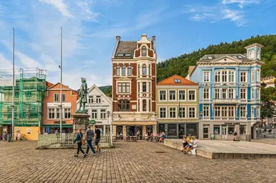 a group of buildings with people walking in a street at Dinbnb Appartments l Live in a postcard ! l 300 m To Bryggen l Value! in Bergen