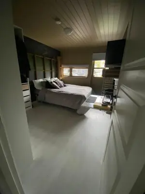 a bedroom with a bed in the middle of it at Hus ski VM 2025 in Trondheim
