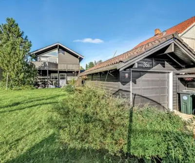a house with a yard next to a building at Hus ski VM 2025 in Trondheim