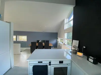 a kitchen with a white counter top in a room at Hus ski VM 2025 in Trondheim