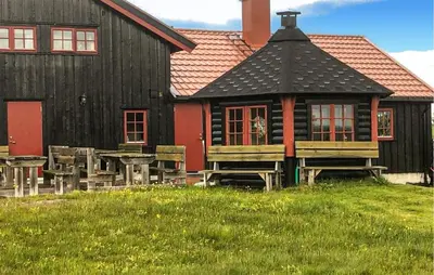 a red and black building with benches in front of it at 4 Bedroom Gorgeous Home In Bagn in Bagn