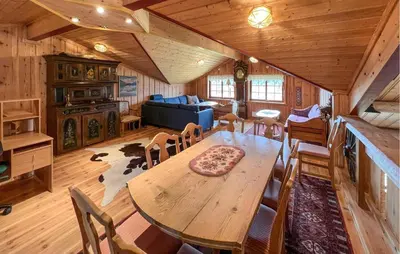 a dining room with a table and chairs in a cabin at 4 Bedroom Gorgeous Home In Bagn in Bagn