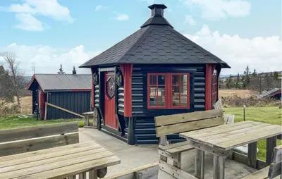 a small blue and red building with two benches at 4 Bedroom Gorgeous Home In Bagn in Bagn