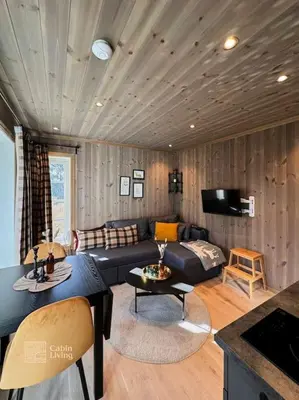 a living room with a couch and a table at Modern apartment with ski in out in Hafjell in Hafjell