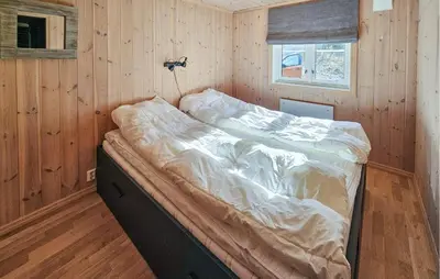 a bedroom with a bed in a wooden room at Gorgeous Home In Gol With Sauna in Gol