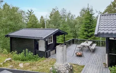 a small cabin with a deck and a bench on it at 3 Bedroom Amazing Home In Eggedal in Eggedal