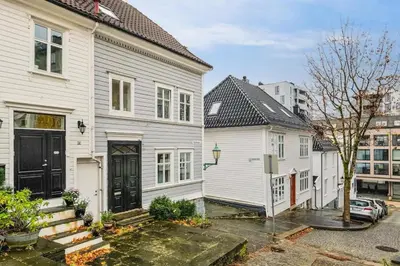 a couple of white houses in a city at Dinbnb Appartments l Traditional bergenshouse I Charming I Familiy in Bergen