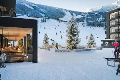 a group of people skiing down a snow covered slope at Ski-in ski-out - Hemsedal Fjellandsbyen in Hemsedal
