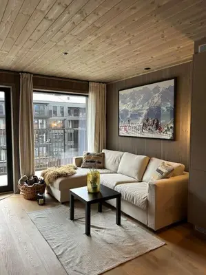 a living room with a couch and a table at Ski-in ski-out - Hemsedal in Fjellandsbyen - view to the slopes in Hemsedal
