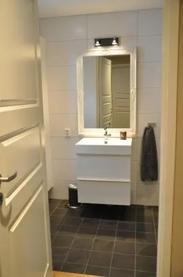 a bathroom with a white sink and a mirror at Leilighet sentralt på Sjusjøen, 11 sengeplasser in Ringsaker