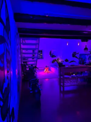a room with purple lights and a room with a table at Top Floor Apartment Trondheim in Trondheim