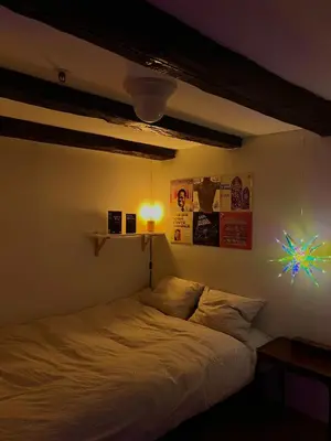 a bedroom with a bed with a light on it at Top Floor Apartment Trondheim in Trondheim