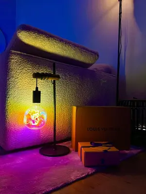 a room with a bed with a lamp and a box at Top Floor Apartment Trondheim in Trondheim